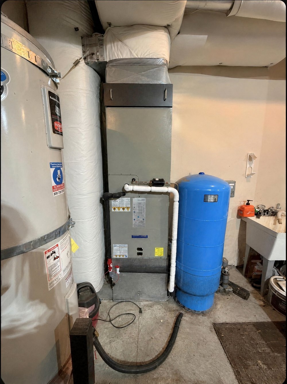 After: the new air handler installed in the same spot, next to the blue pressure tank