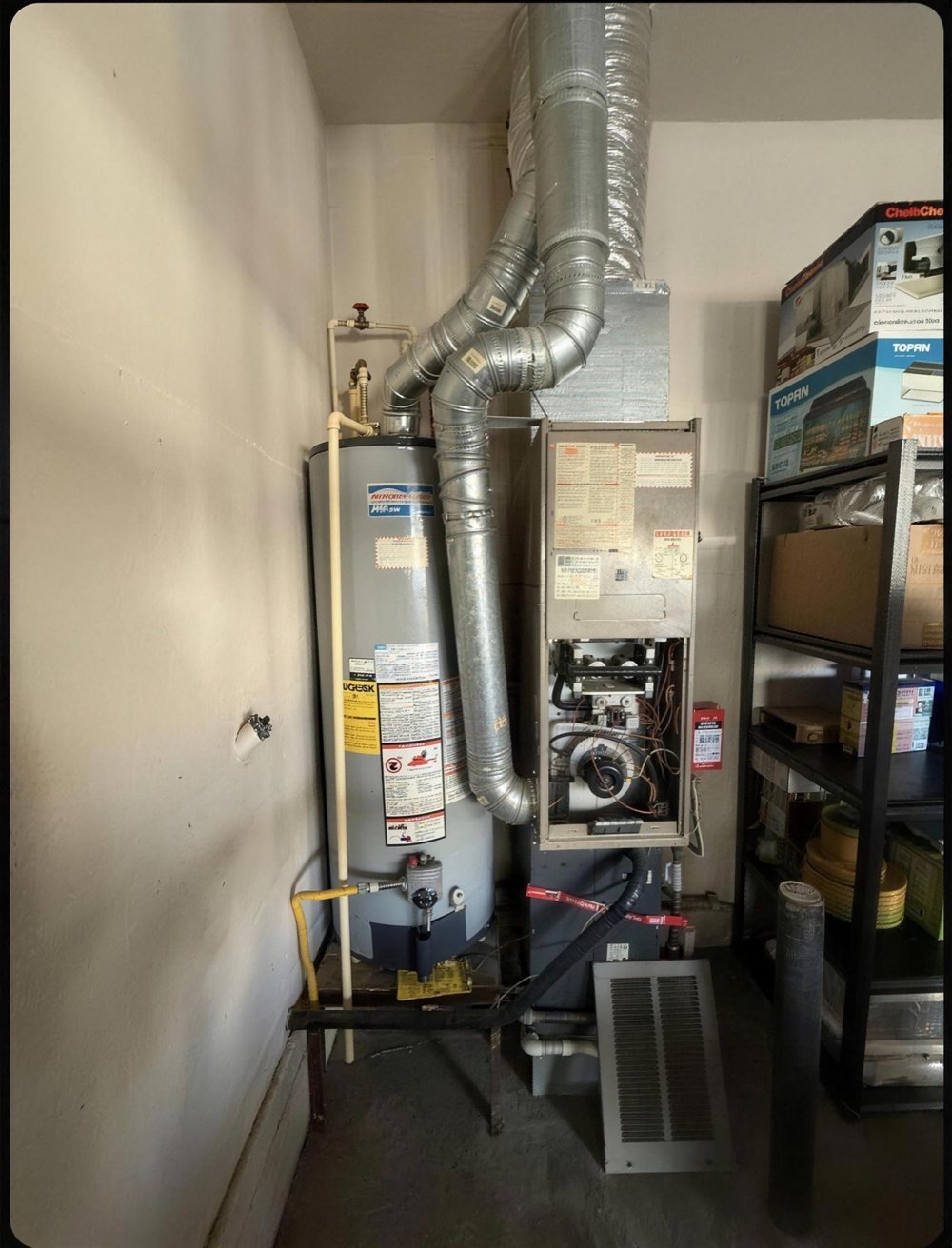 Before: an old furnace in a garage next to the water heater