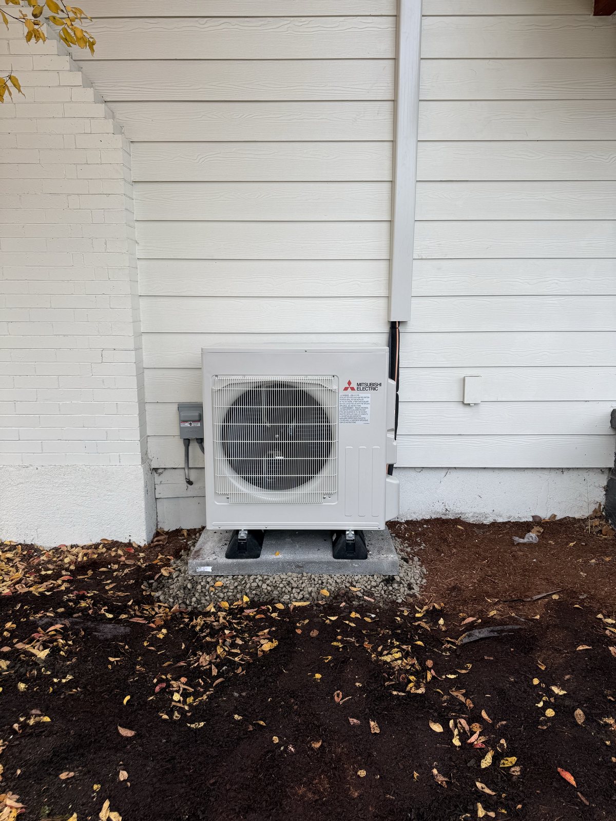 A Mitsubishi Electric heat pump Pacific Peak installed on a concrete pad in Vancouver, WA
