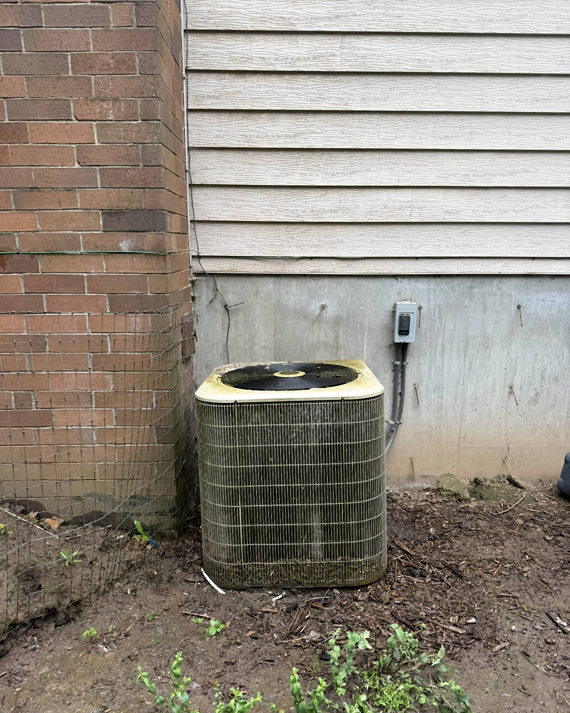 Before: old algae-covered ground-mount AC condenser
